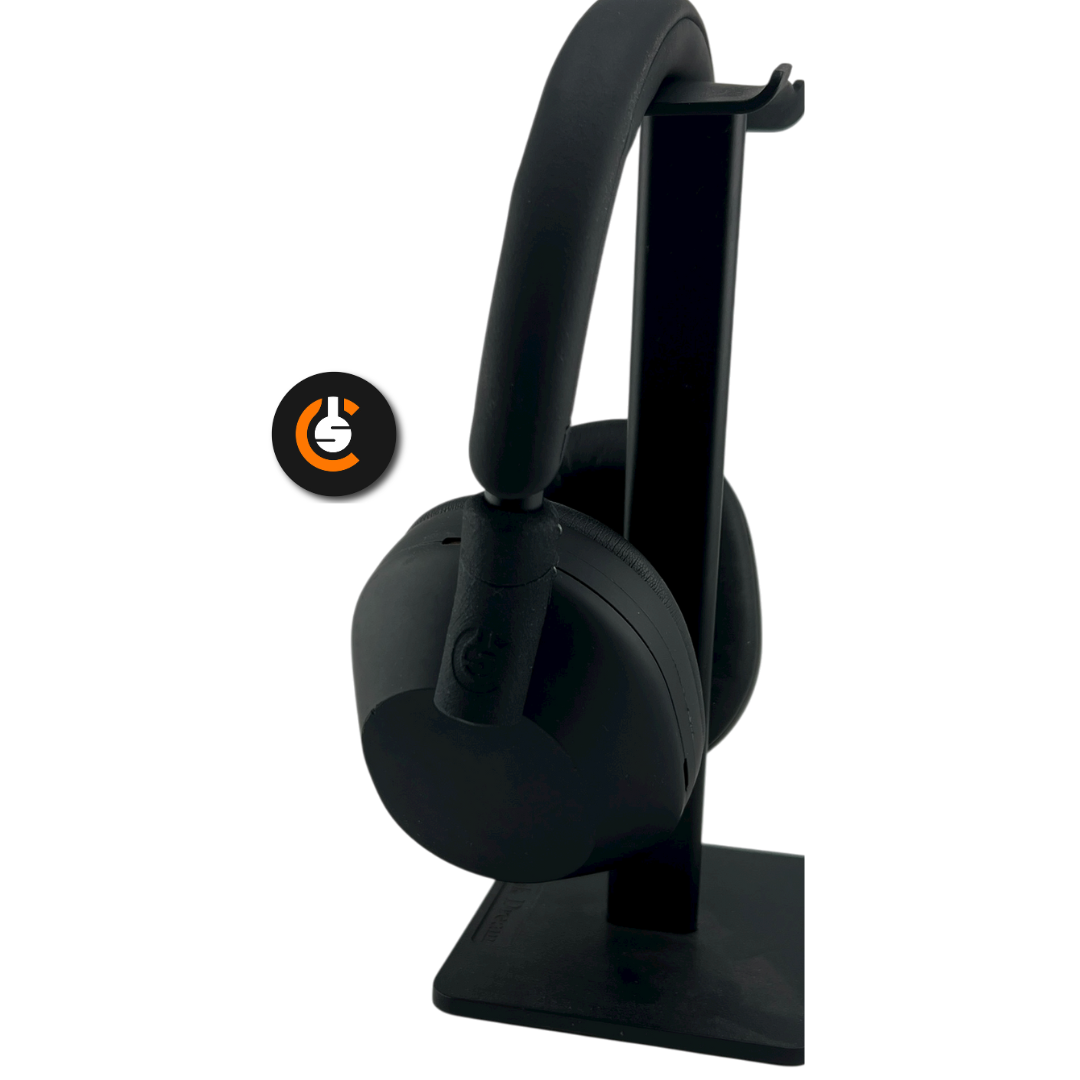 Black headphones on a stand with a circular logo beside them.